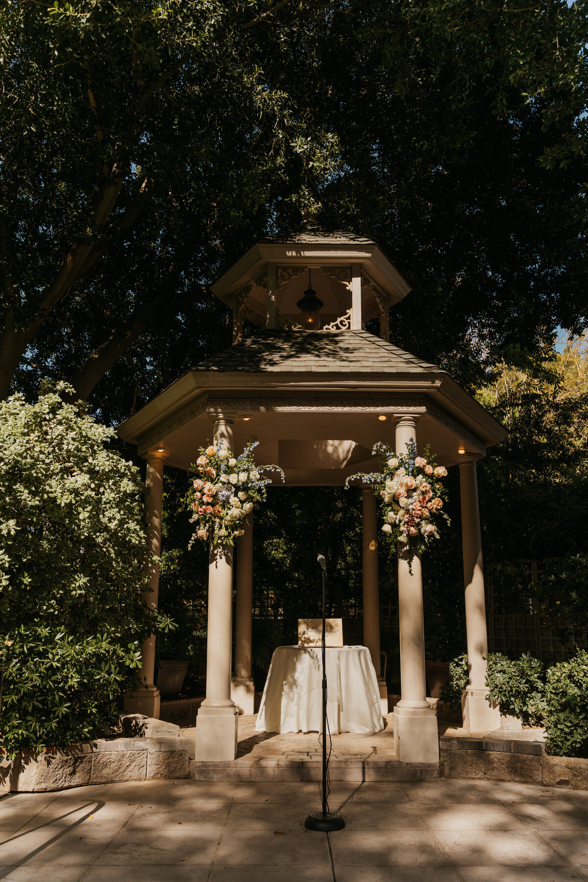 A small altar set up in a gazebo for a wedding 