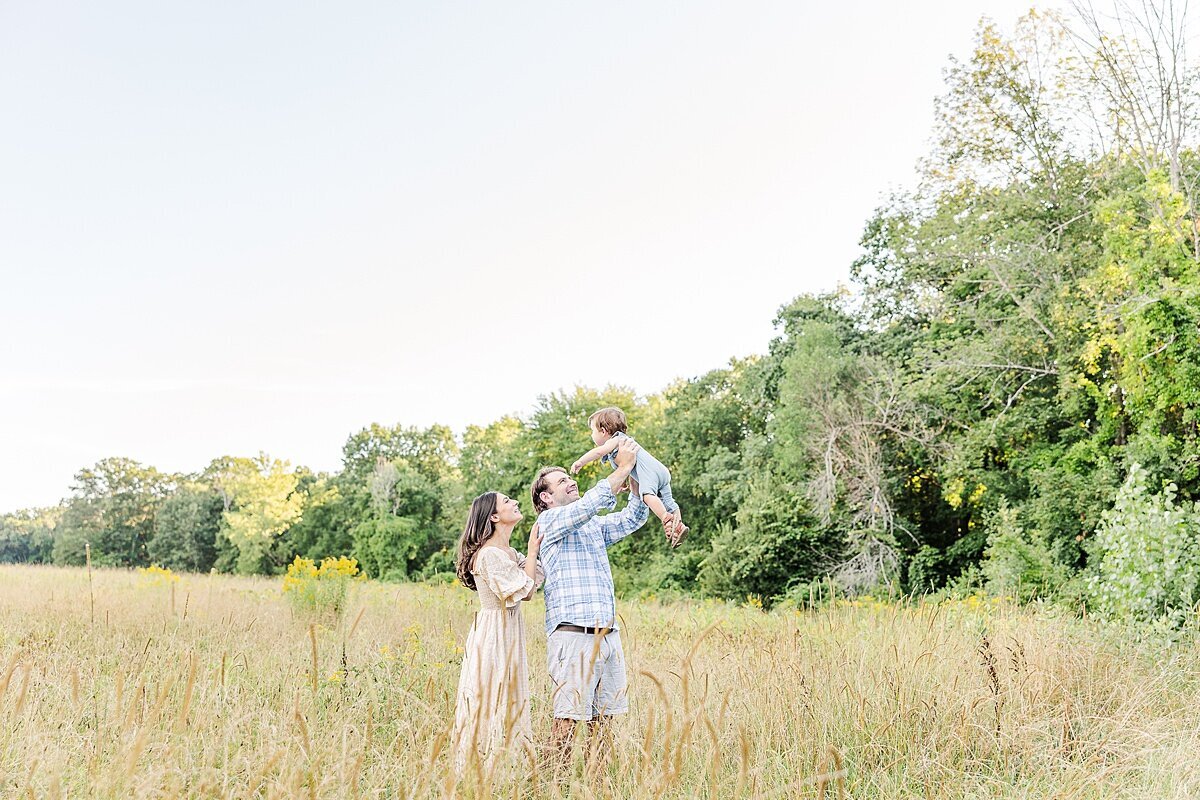 family stands in field during Family photo session with Sara Sniderman Photography at Heard Farm in Wayland Massachusetts