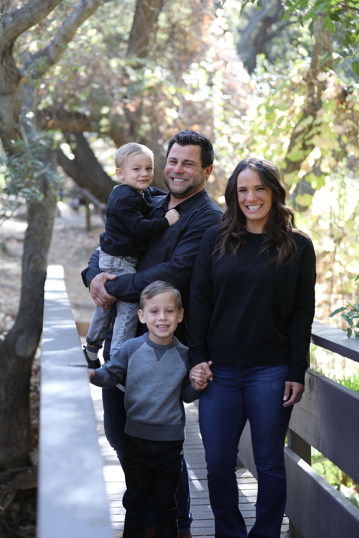 KS-Gray-Photography-family-portraits-in-orange-county-family-standing-together-on-bridge