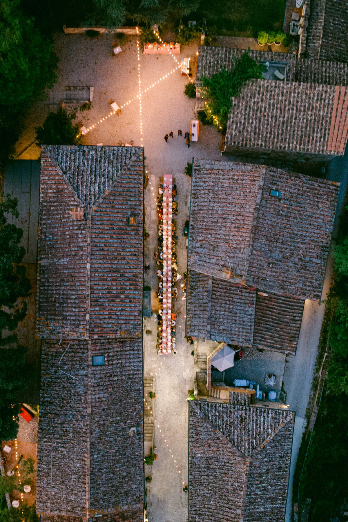 A wedding aerial drone photo of the welcome dinner at a wedding at Laticastelli in Tuscany Italy