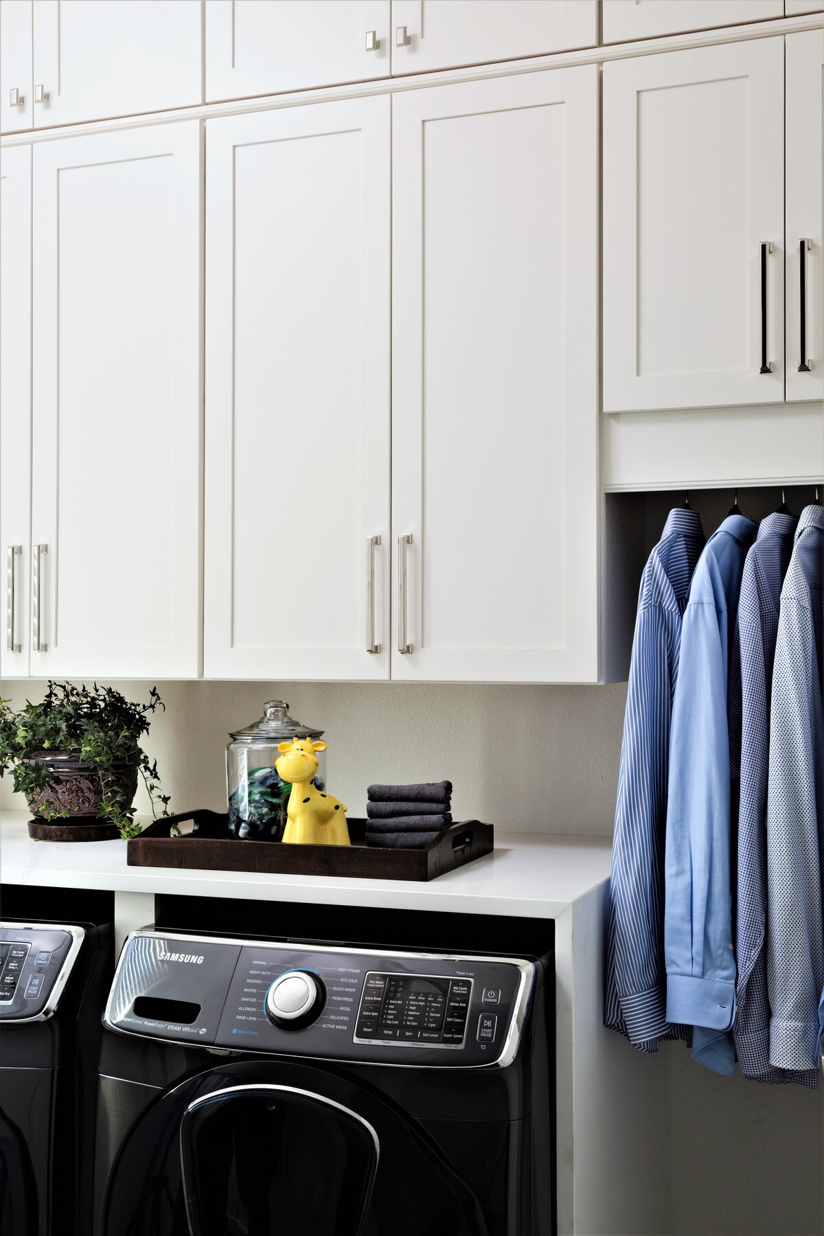 Organized Washing Area with White Cupboards