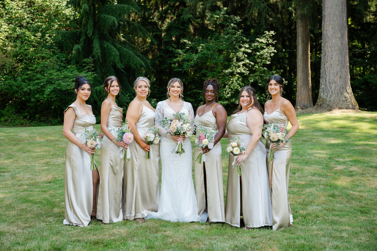 seattle bridesmaids in champagne colored dresses with pastel bouquets