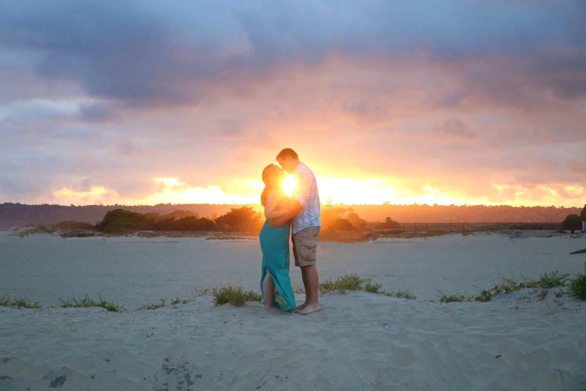 Couple at sunset engagement session at Coronado beach, California