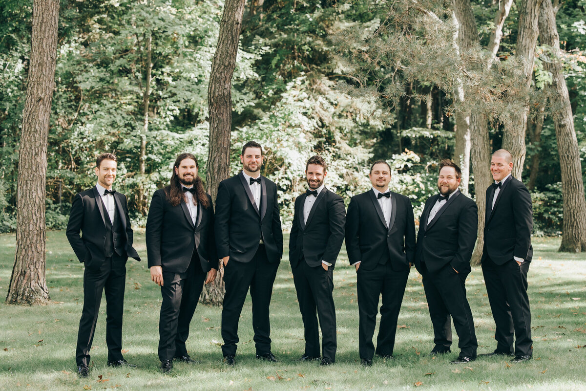 Groom and groomsmen wearing charcoal suits photographed by Nova Markina