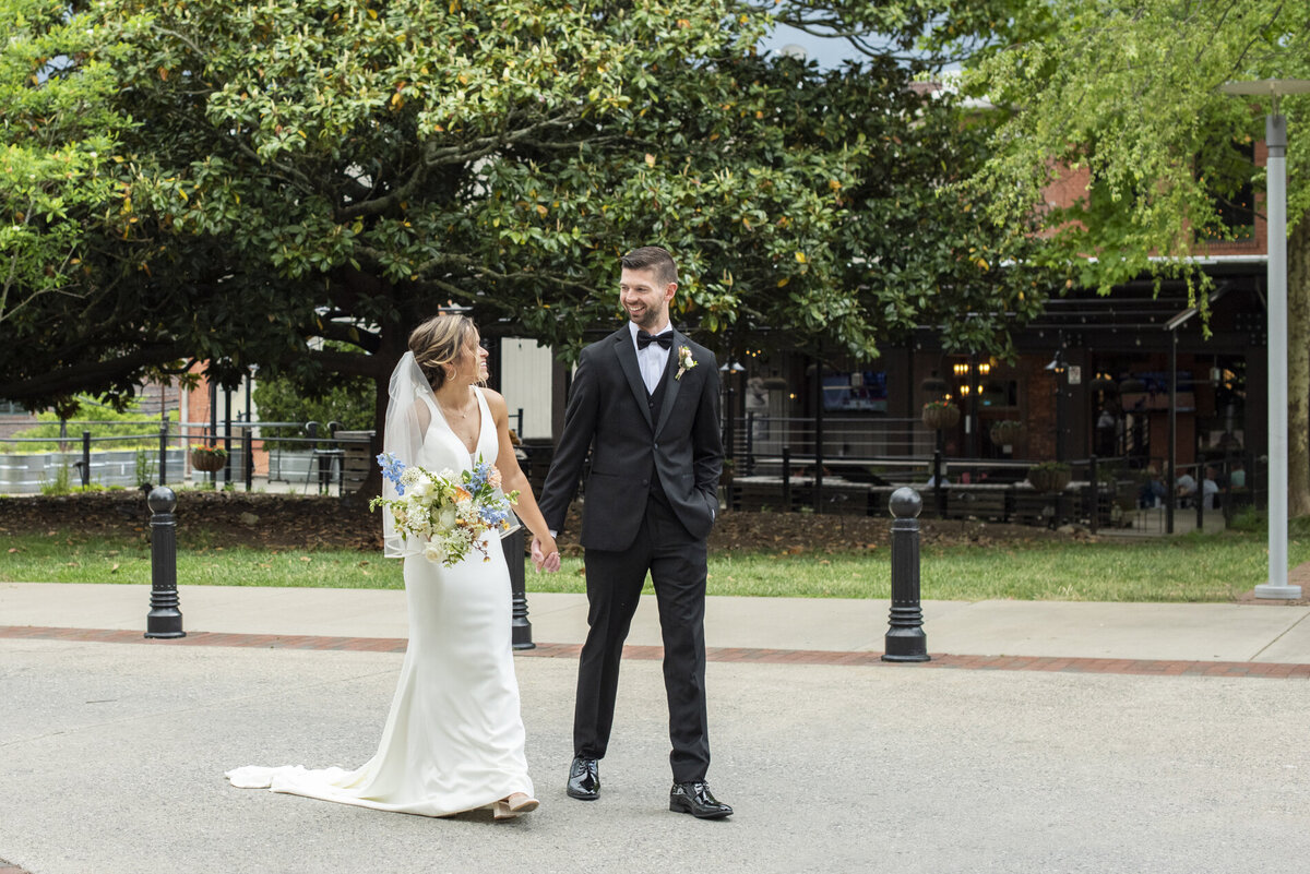 couple walking at wedding at Century Room on the Park Asheville wedding