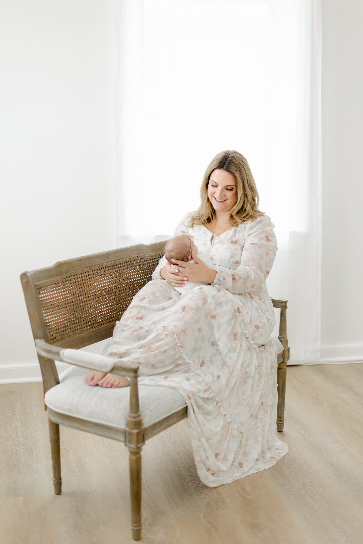 beautiful mom holding baby girl in Philadelphia Newborn Photographer Tara Federico's Haddonfield Studio