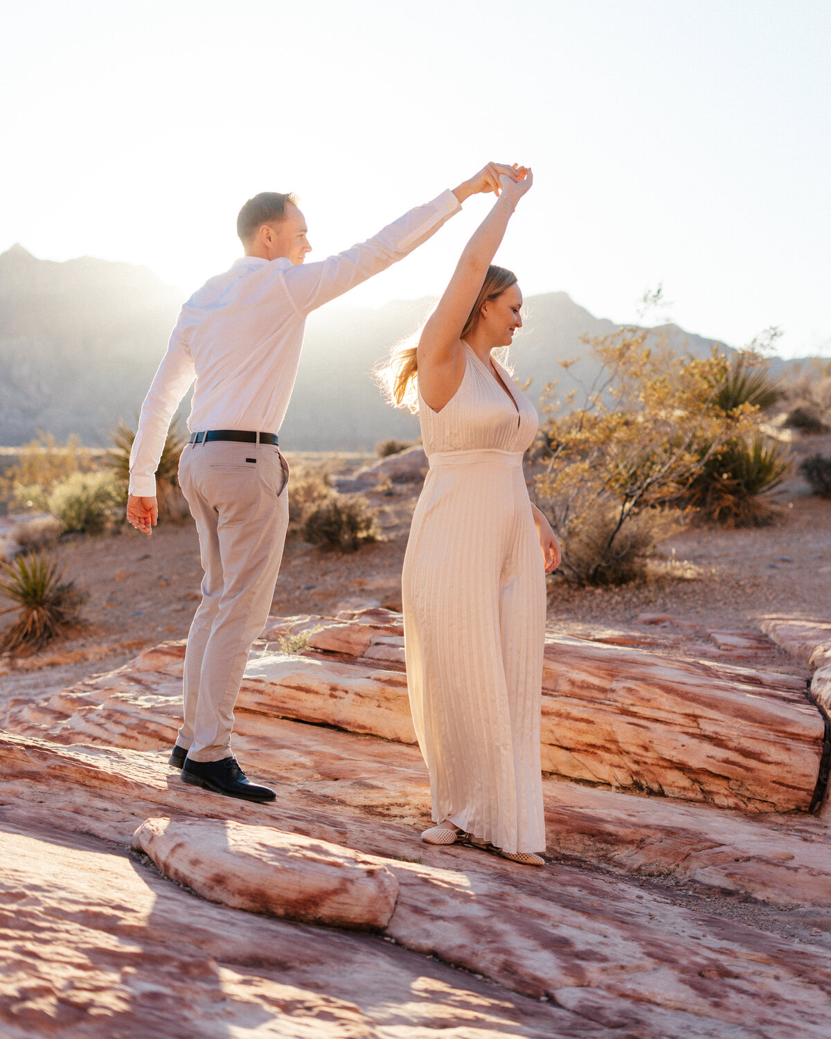 couple dancing in the golden light at red rock canyon in nevada