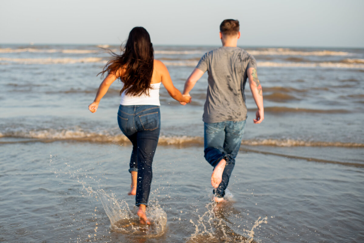 Celebrate the sheer joy of an engagement as this couple runs hand in hand along the beautiful beaches of Galveston, Texas, where their love shines bright.