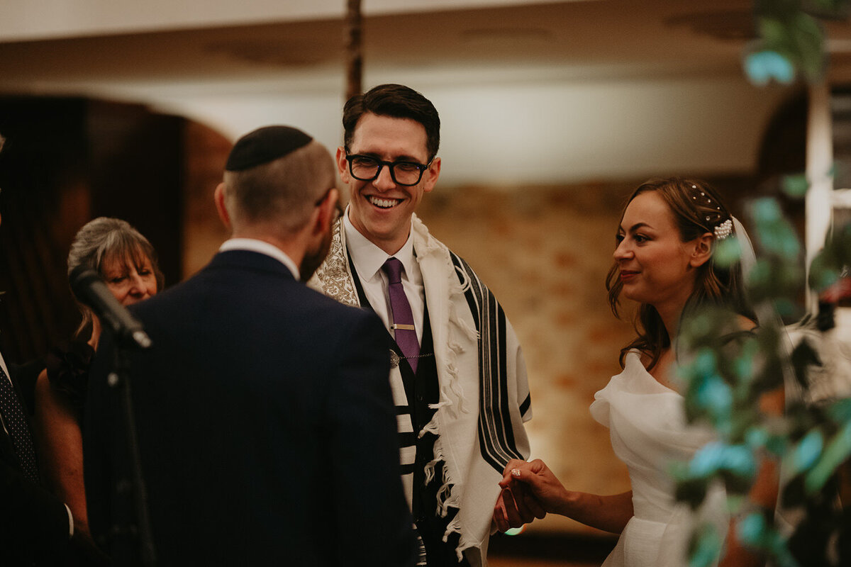 Groom smiles during his wedding at The Barbican in London. 
