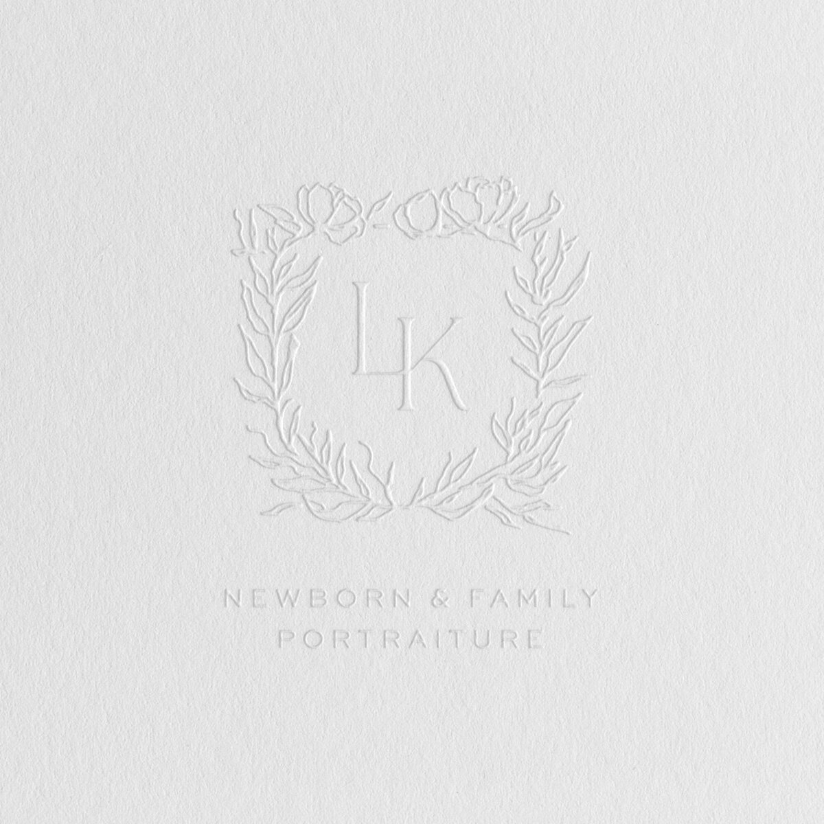 a mockup showing a crest logo embossed on to stationery