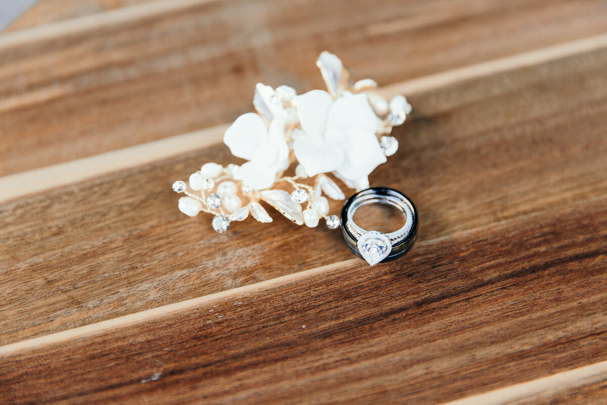 engagement ring and hair clip on wooden table