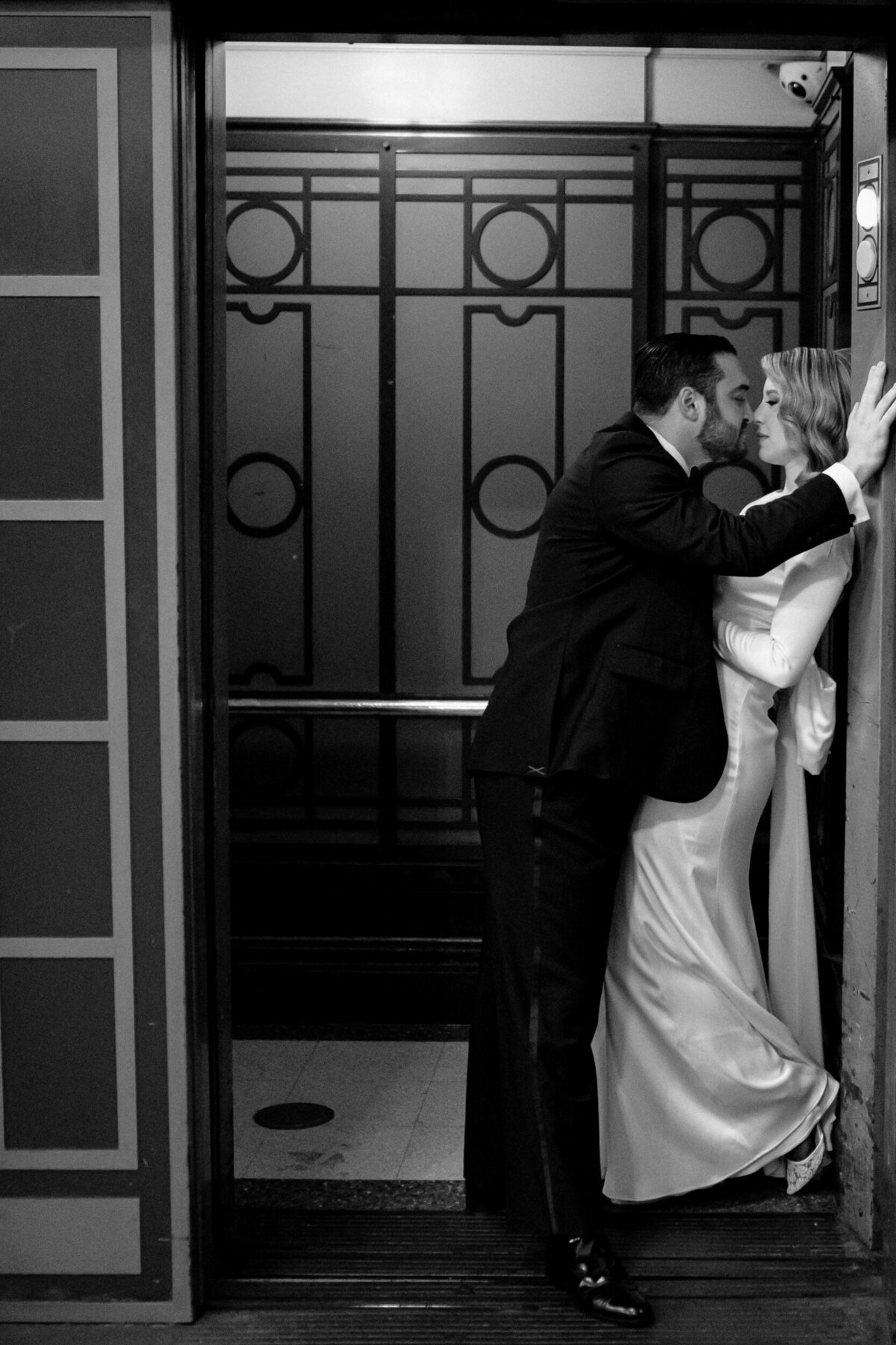 Bride and Groom kissing inside of an elevator after their elopement.