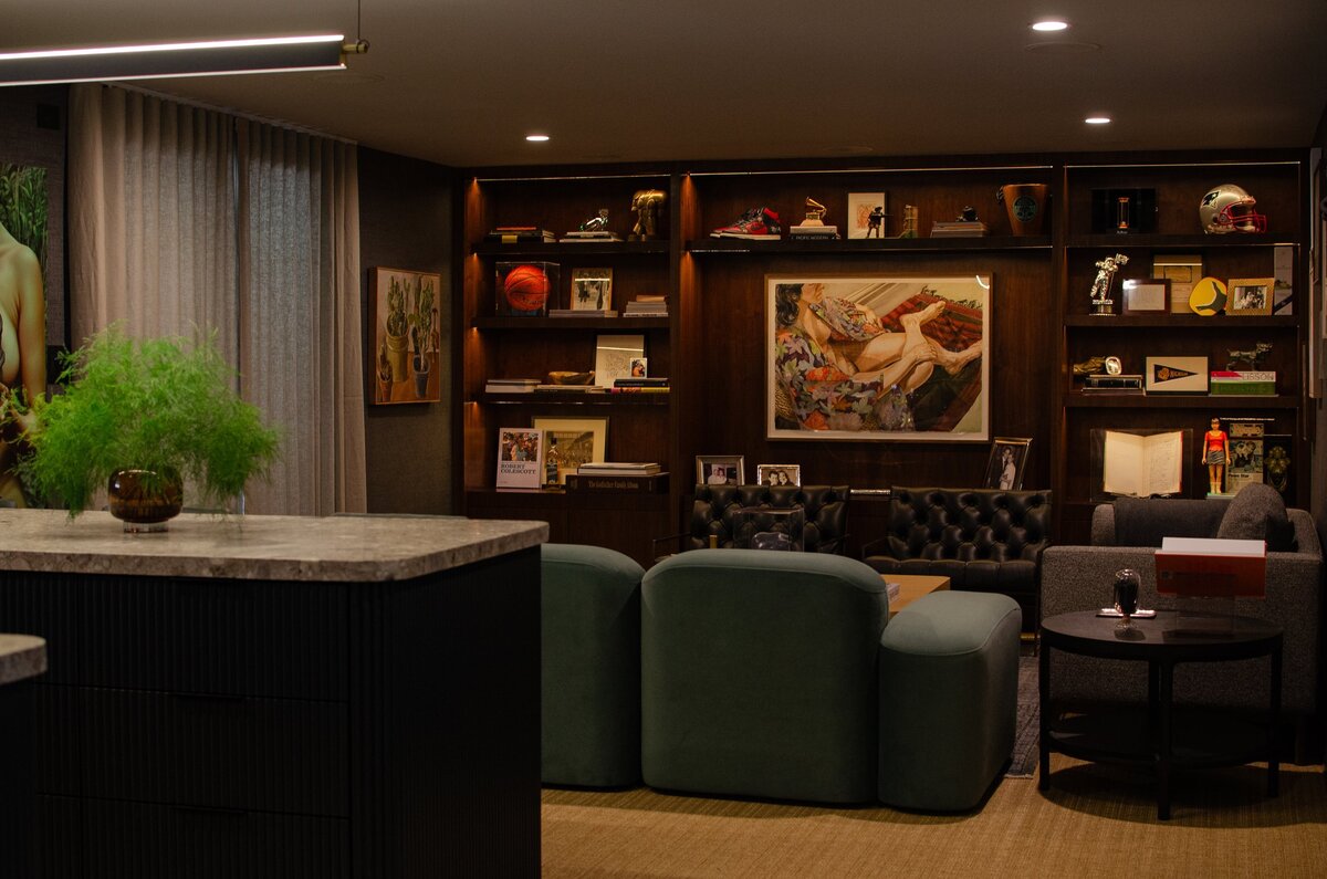 dark moody basement wet bar interior design Los Angeles custom built ins bespoke mood lighting fine art liquor bar display mirrored backsplash minimal ambient design ideas plans mini bar
