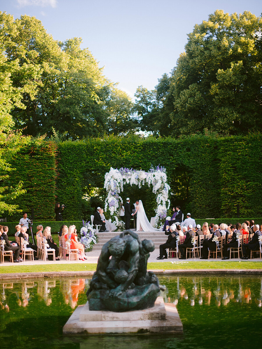 Musee Rodin Wedding by Alejandra Poupel Events Bride and groom making vows and family 