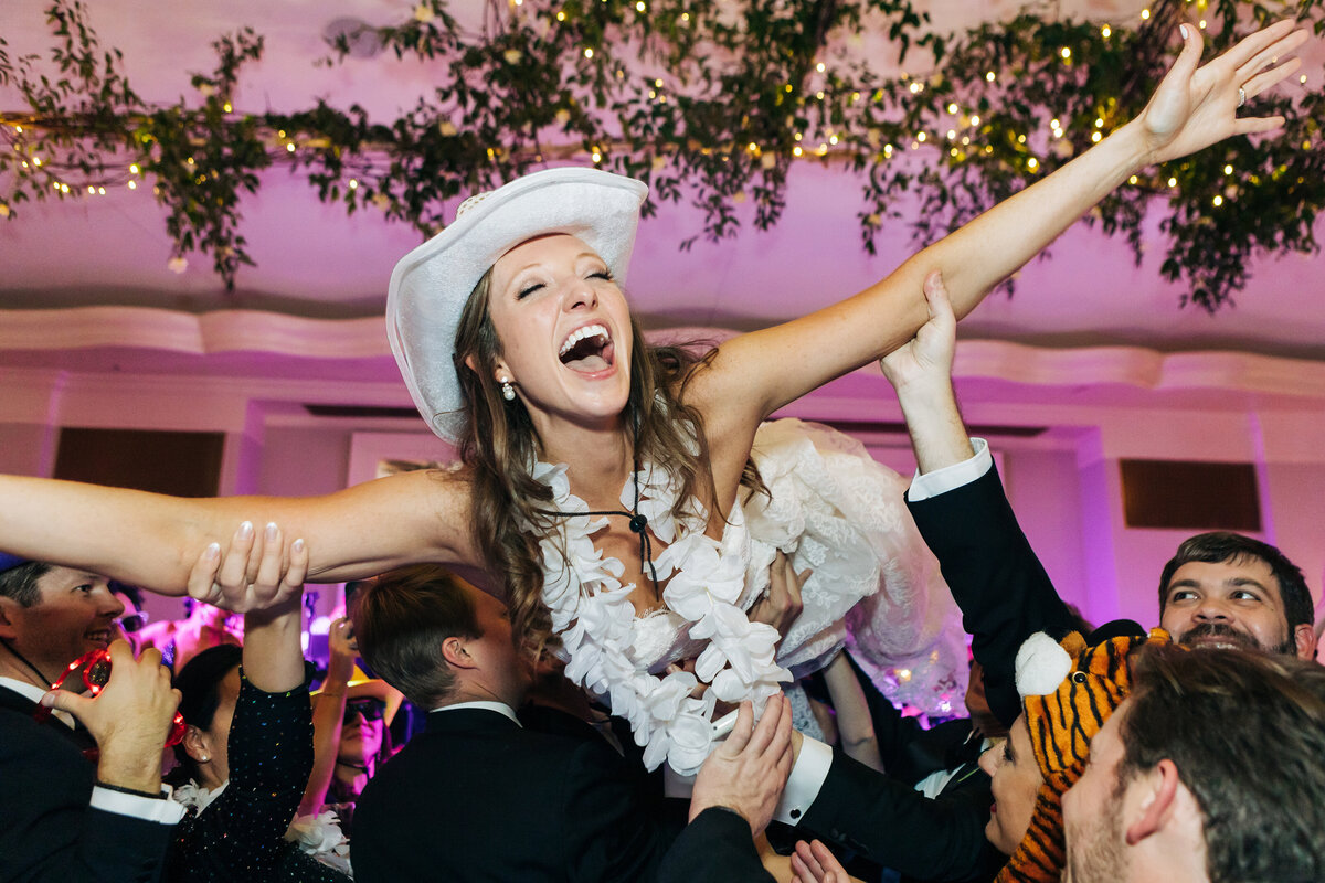 Woman crowdsurfing at the wedding reception