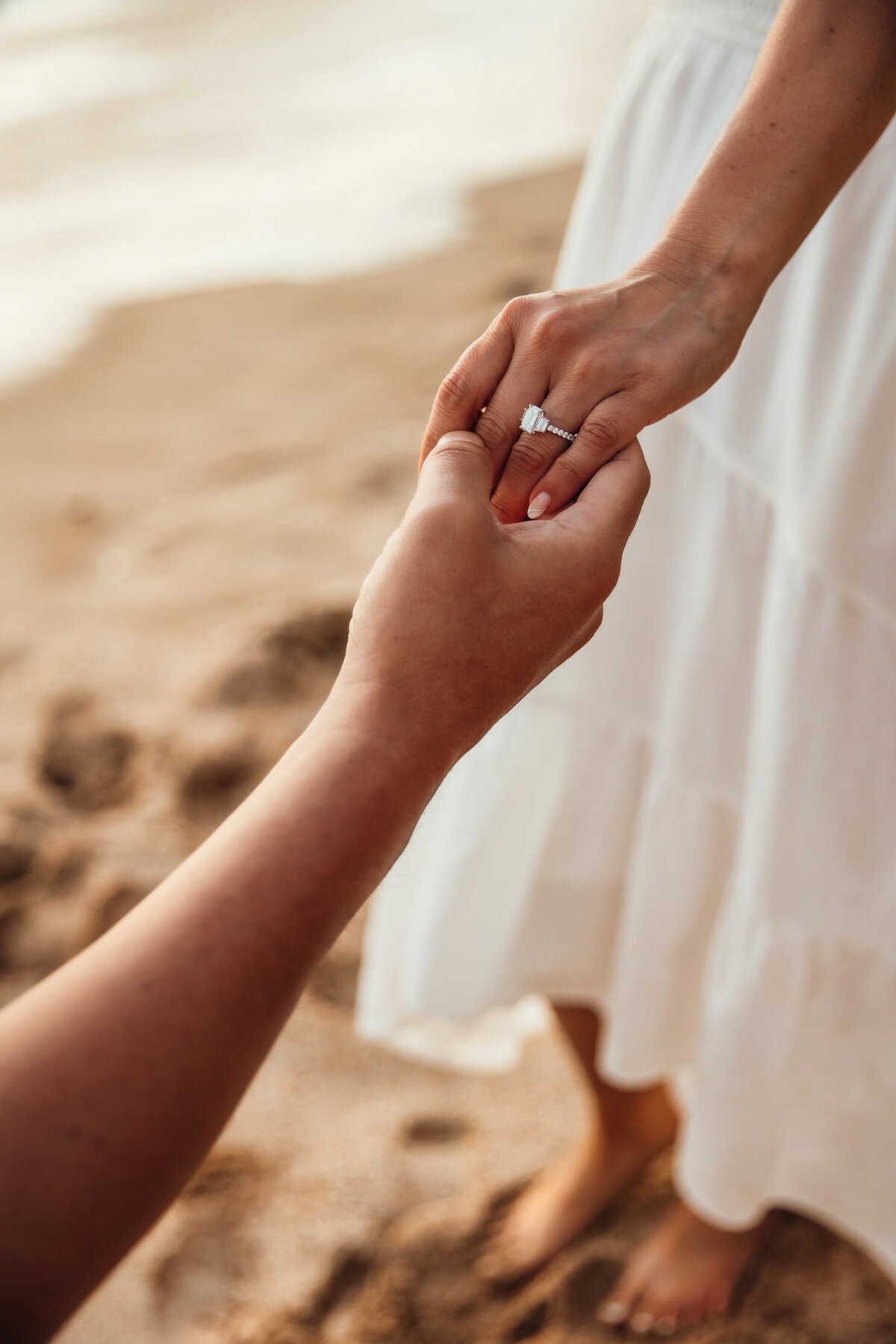 Hawaii Engagement Photographer captures woman with engagement ring on finger