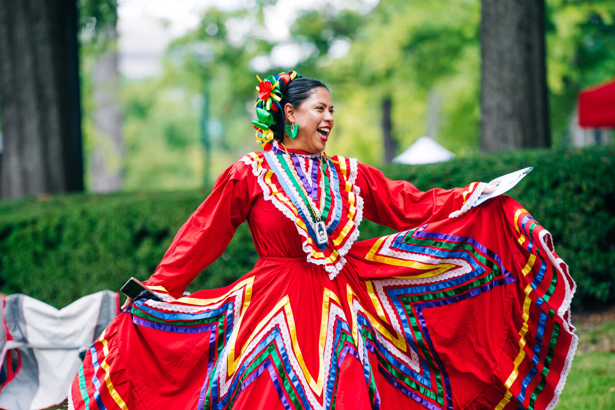 little boy wearing a jacket standing outside at sunset