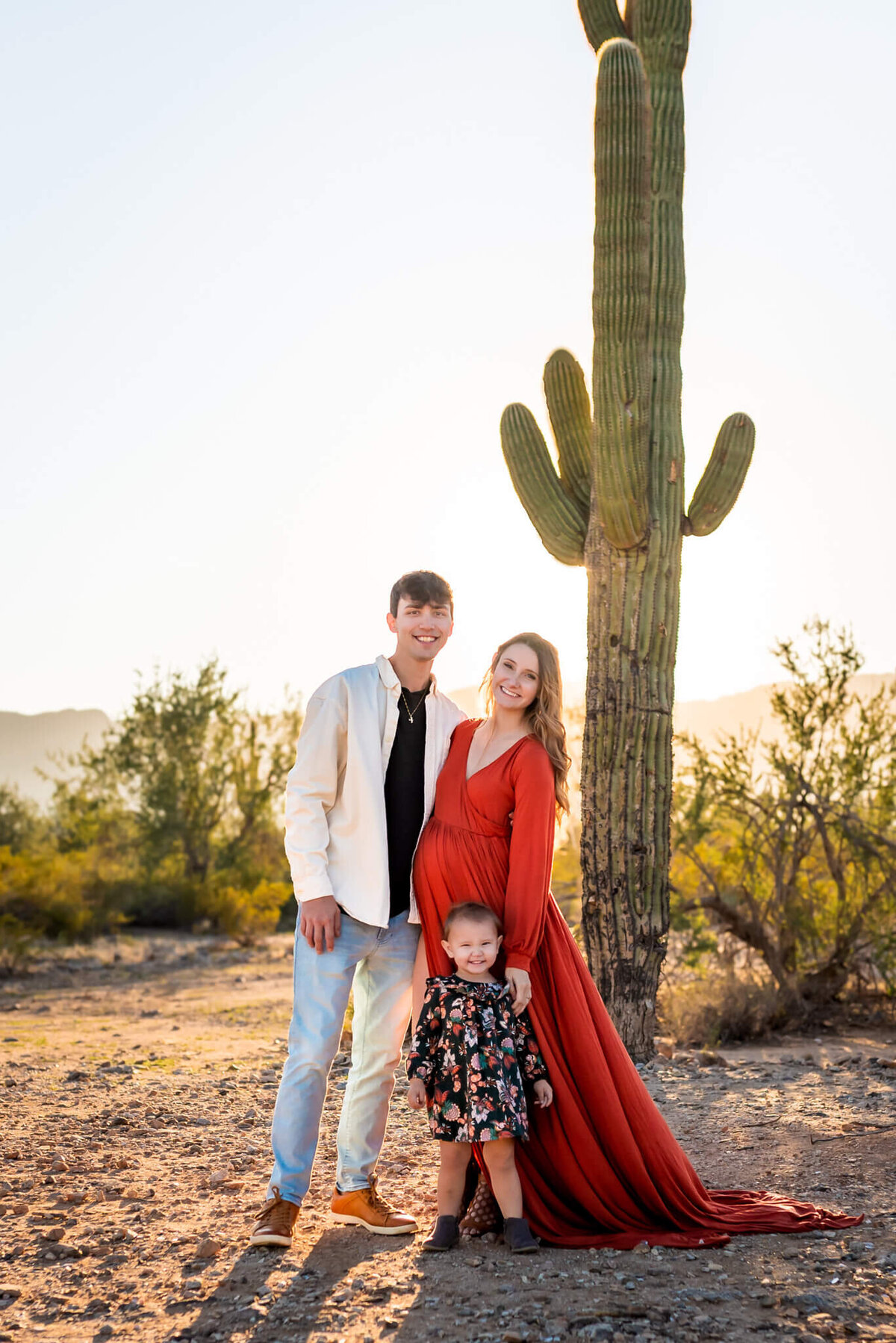 young Arizona family smiling together for maternity photos.