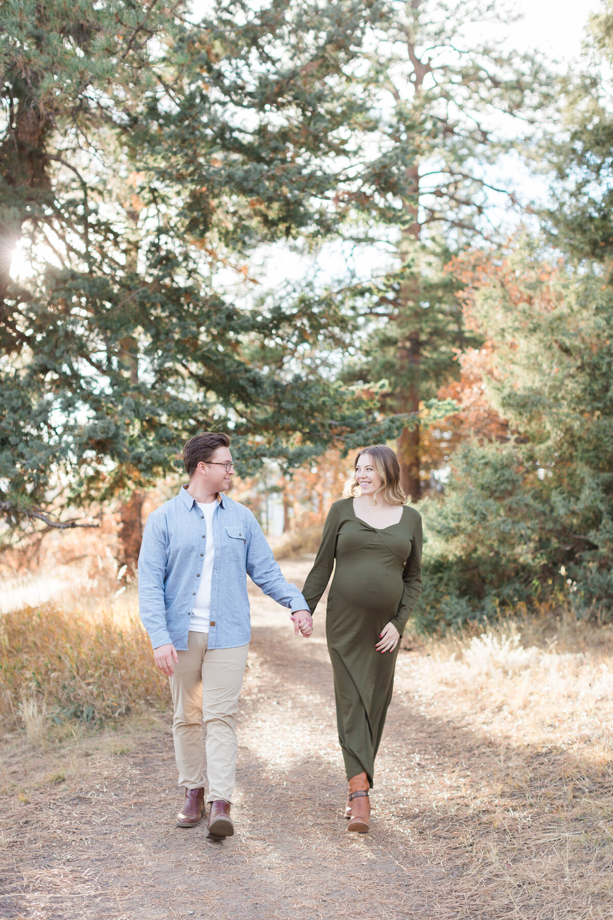 A couple walking during their mountain maternity session