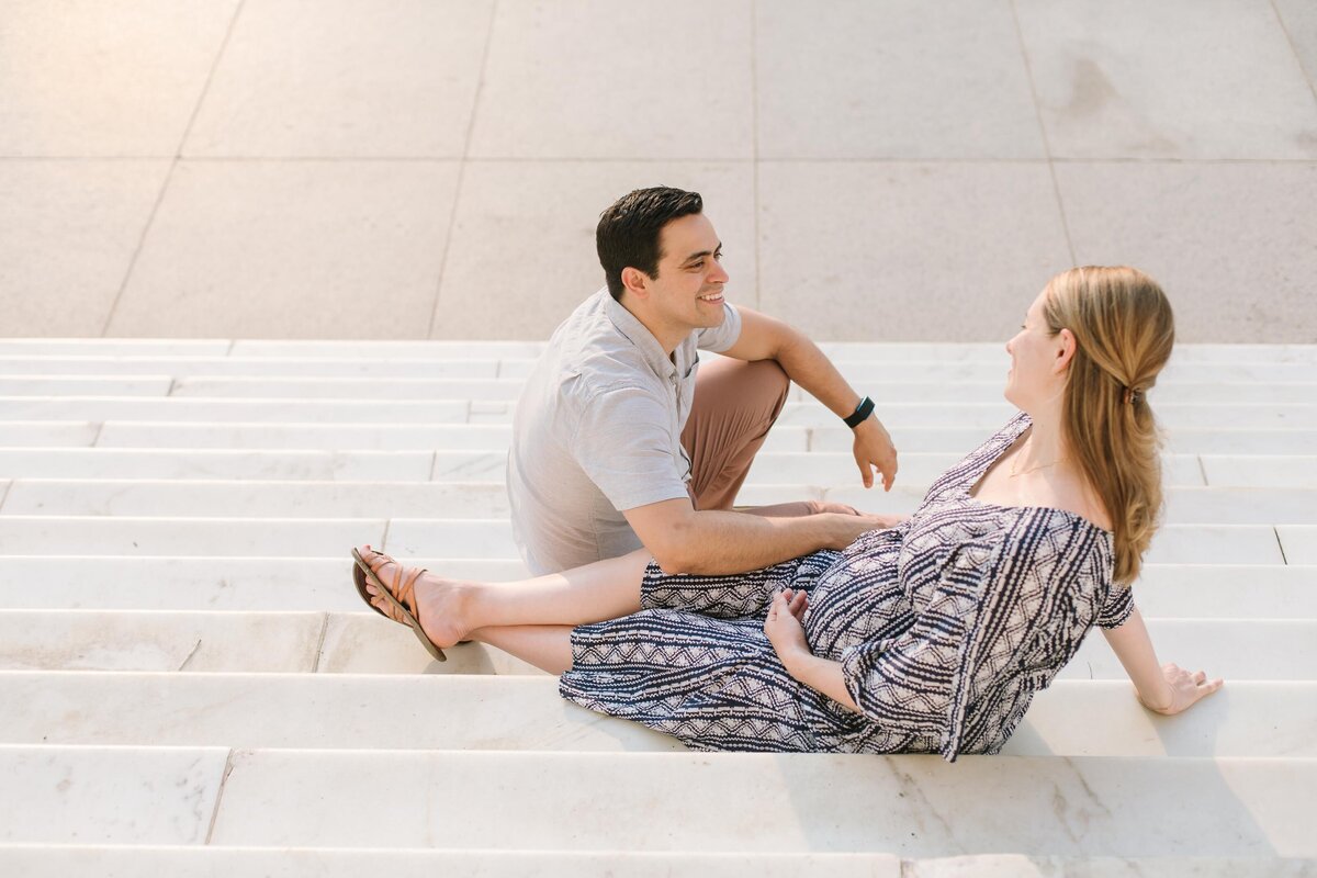pregnant woman and husband sitting on lincoln memorial steps in washington dc