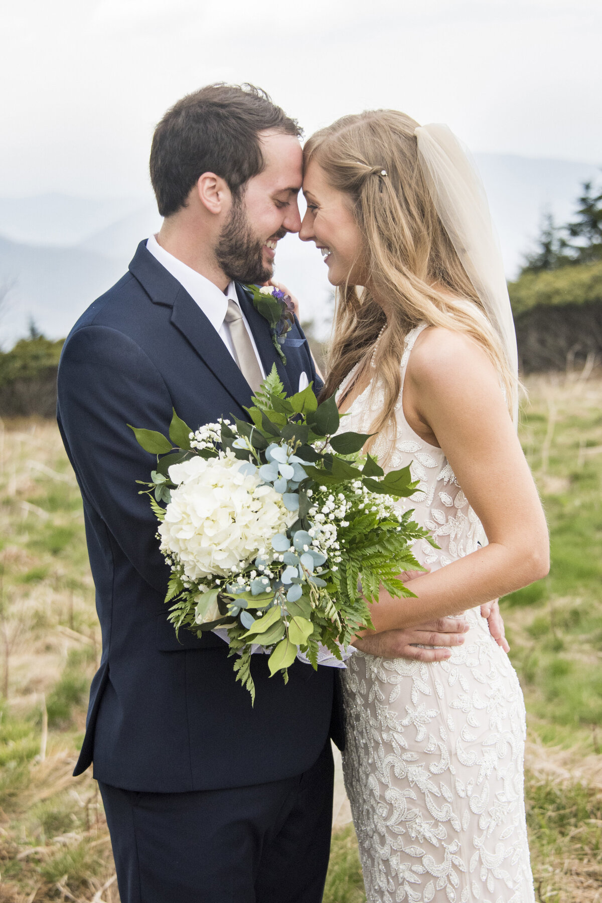 Wedding photography mountain top Asheville, NC couple touching noses