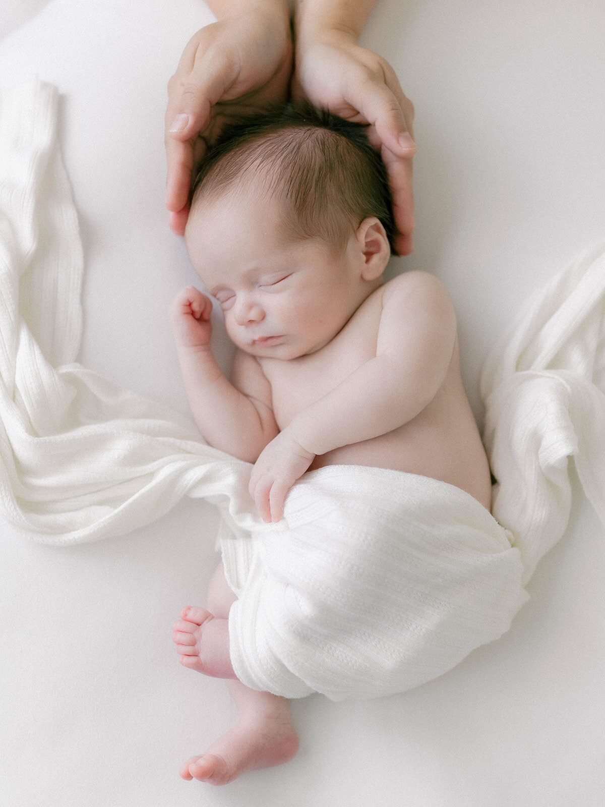 Mom holding newborn baby's head