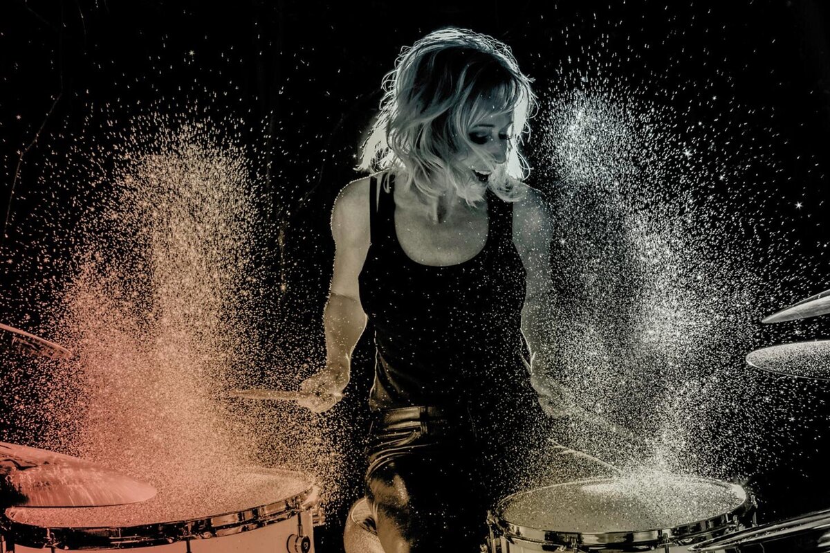 Female Drummer Portrait Andra Liemandt playing drums sparkles floating in air around her Just Play Something Gallery