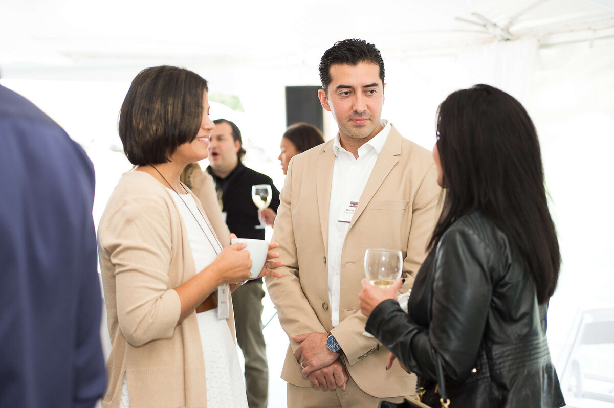 a candid photo of guests mingling at a corporate anniversary celebration.  Captured by Ottawa Event Photographer JEMMAN Photography COMMERCIAL