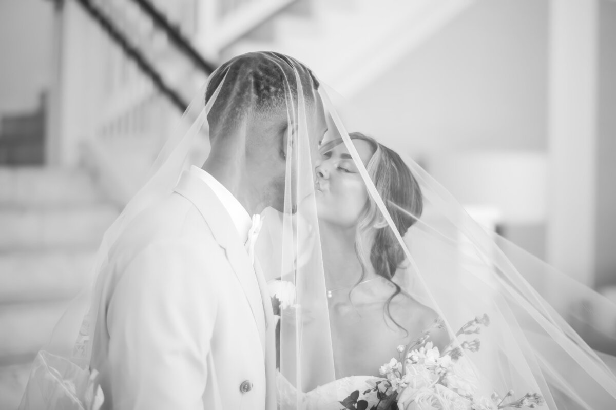 couple kissing under a veil