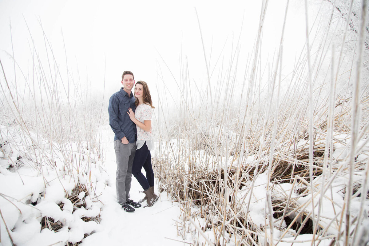 A couple posing for a n engagement portrait with Jessica Bowles