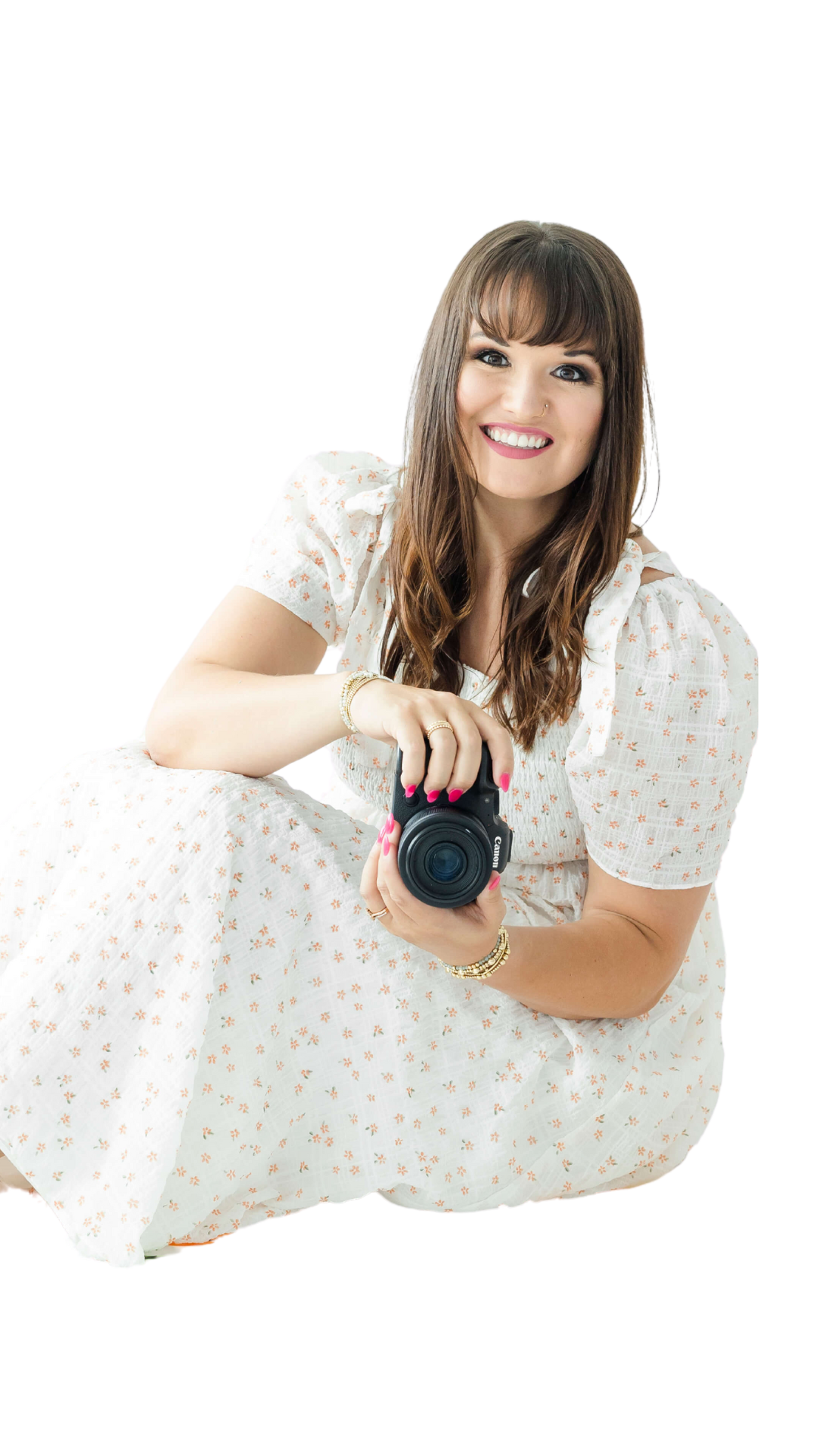 Josie sitting holding camera while smiling
