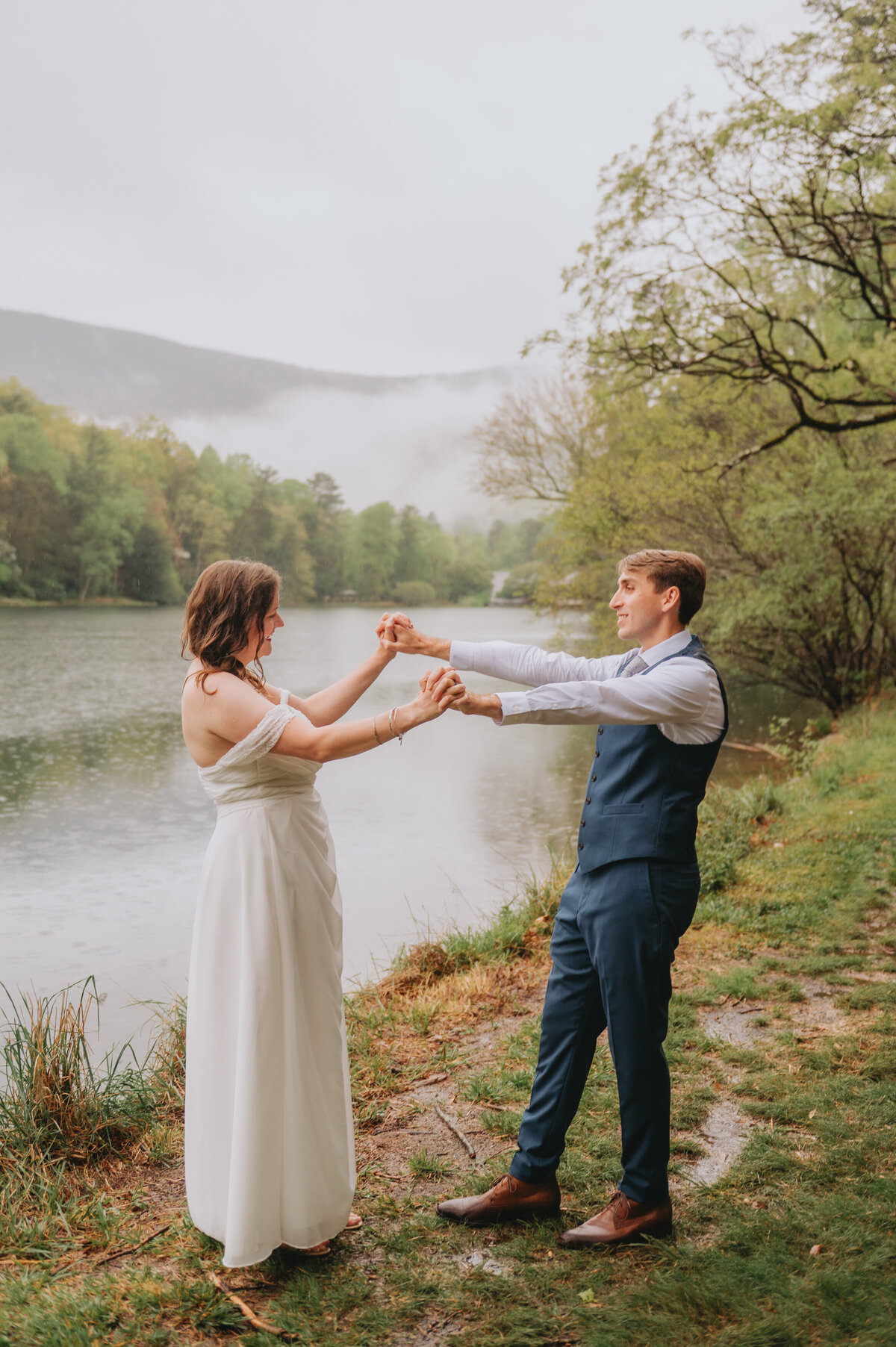 A couple holds hands in front of a river