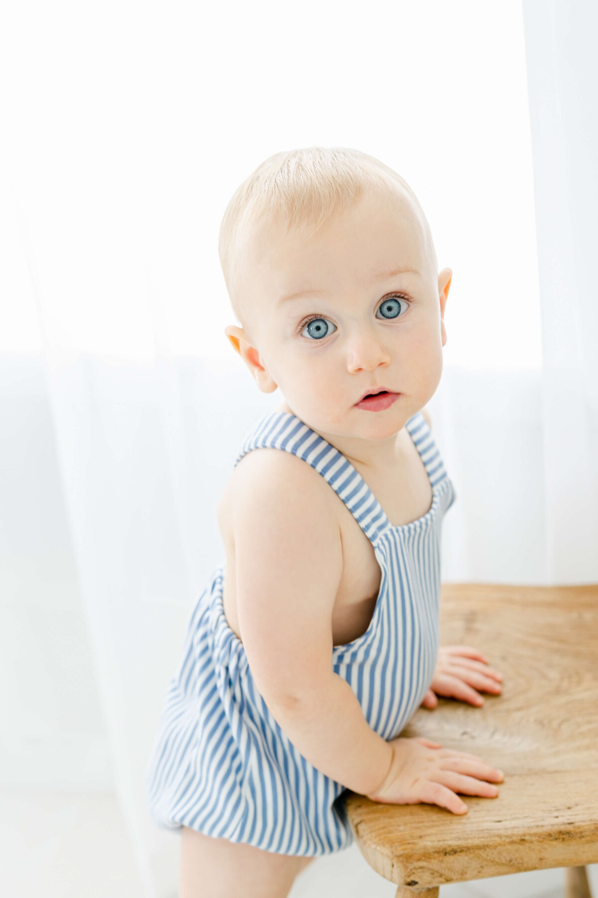 a portrait of a baby looking curious