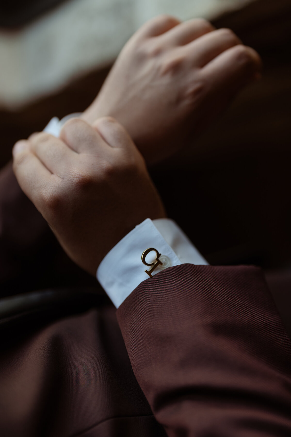 A stylish image of the groom adjusting his cufflinks, emphasizing attention to detail at the Dallas wedding venue.