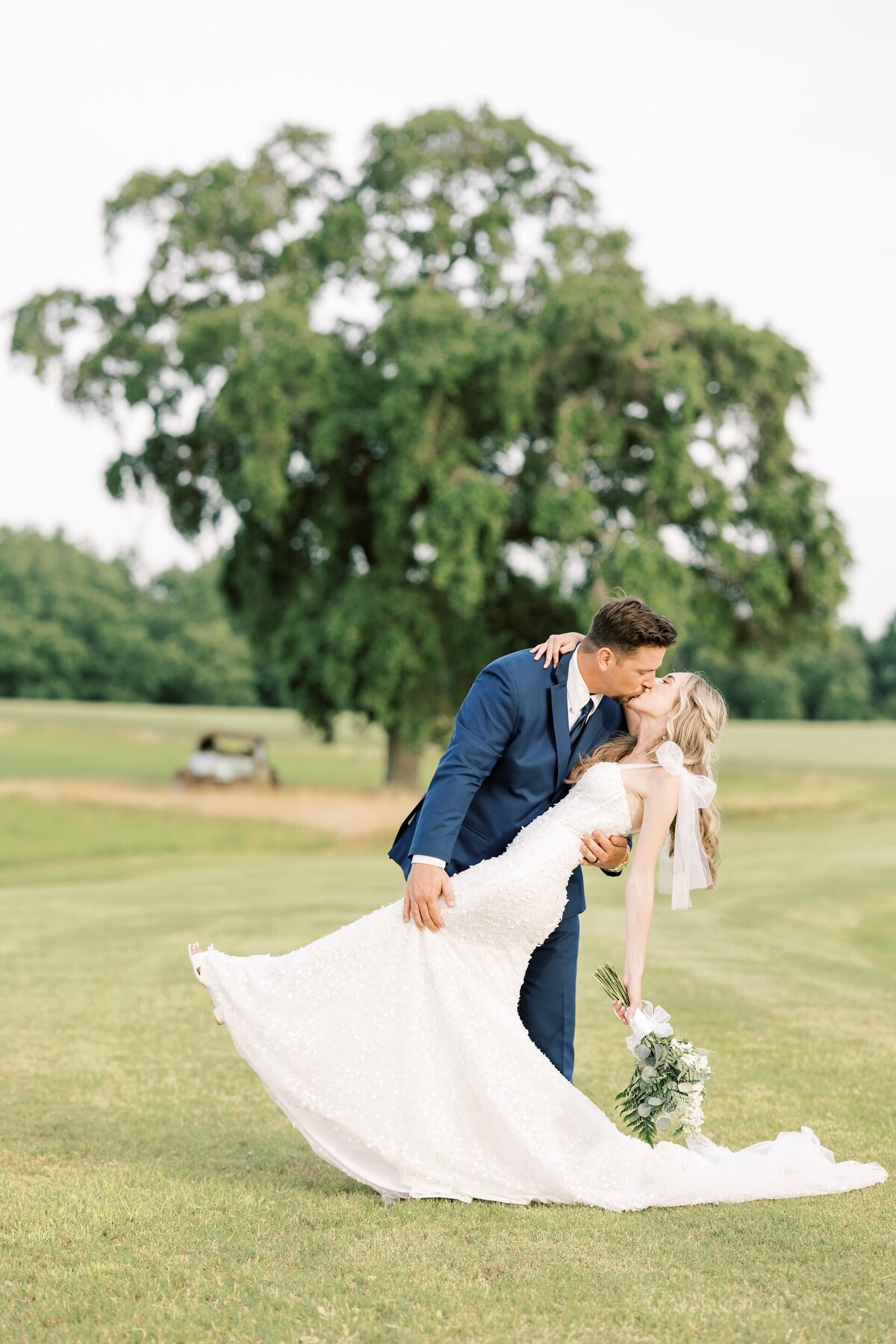 groom dipping and kissing his bride