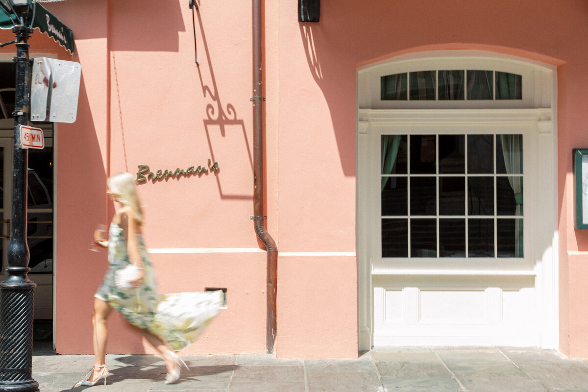 girl blurred walking in front of Brennan's Resturant