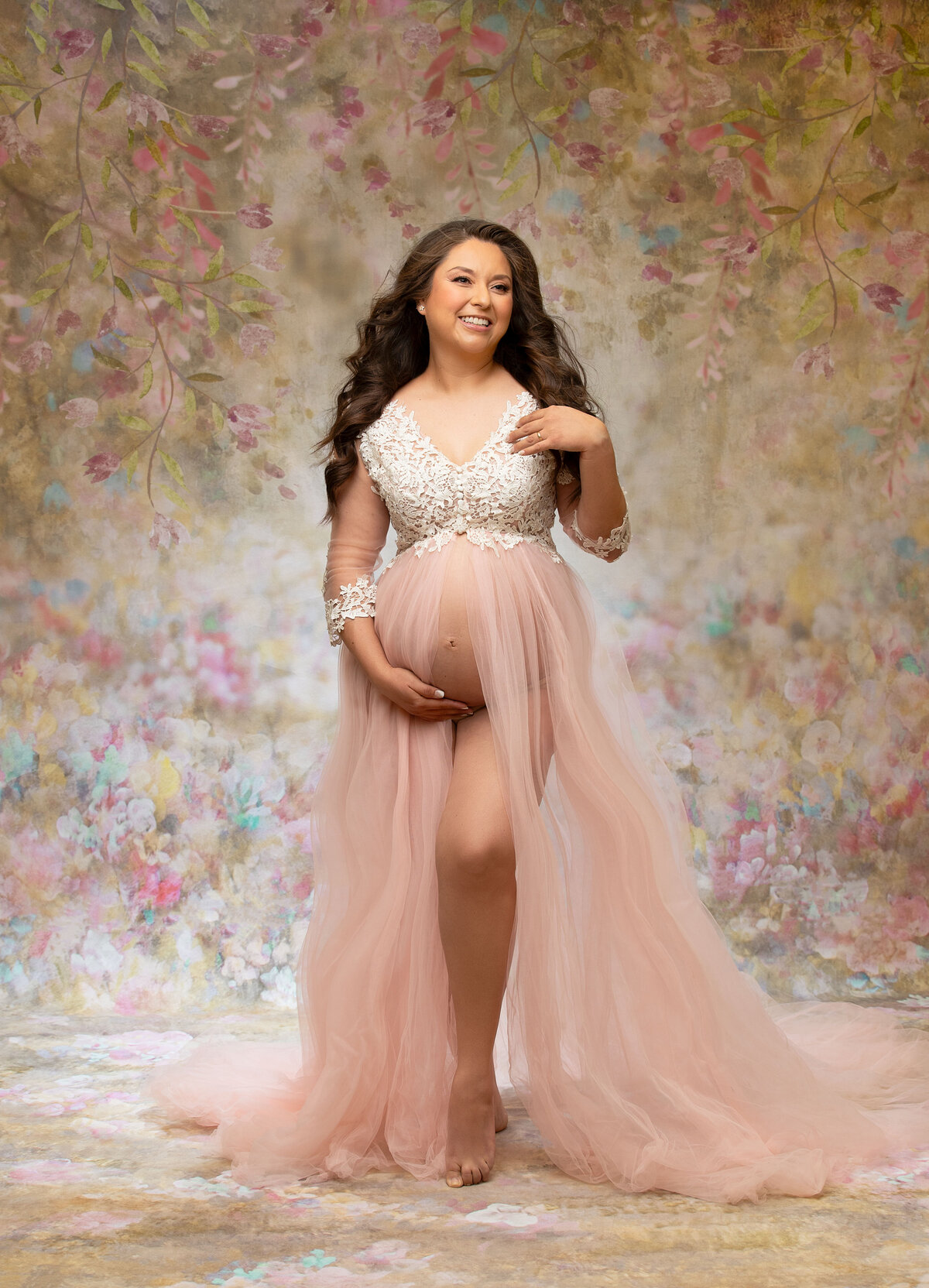 An expectant mom glows in a cream gown with soft studio lighting, embodying the peaceful essence of pregnancy in Phoenix Arizona