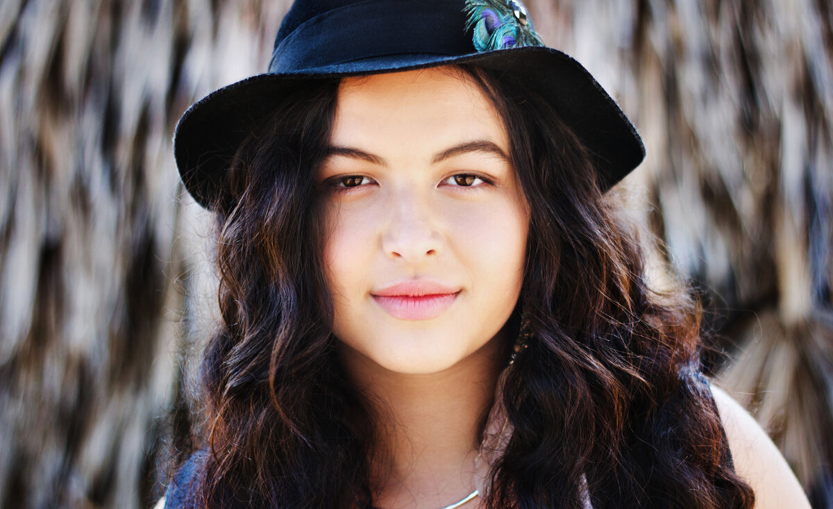 Counrty music photo Danelle Prow close up wearing black cowboy hat palm tree background