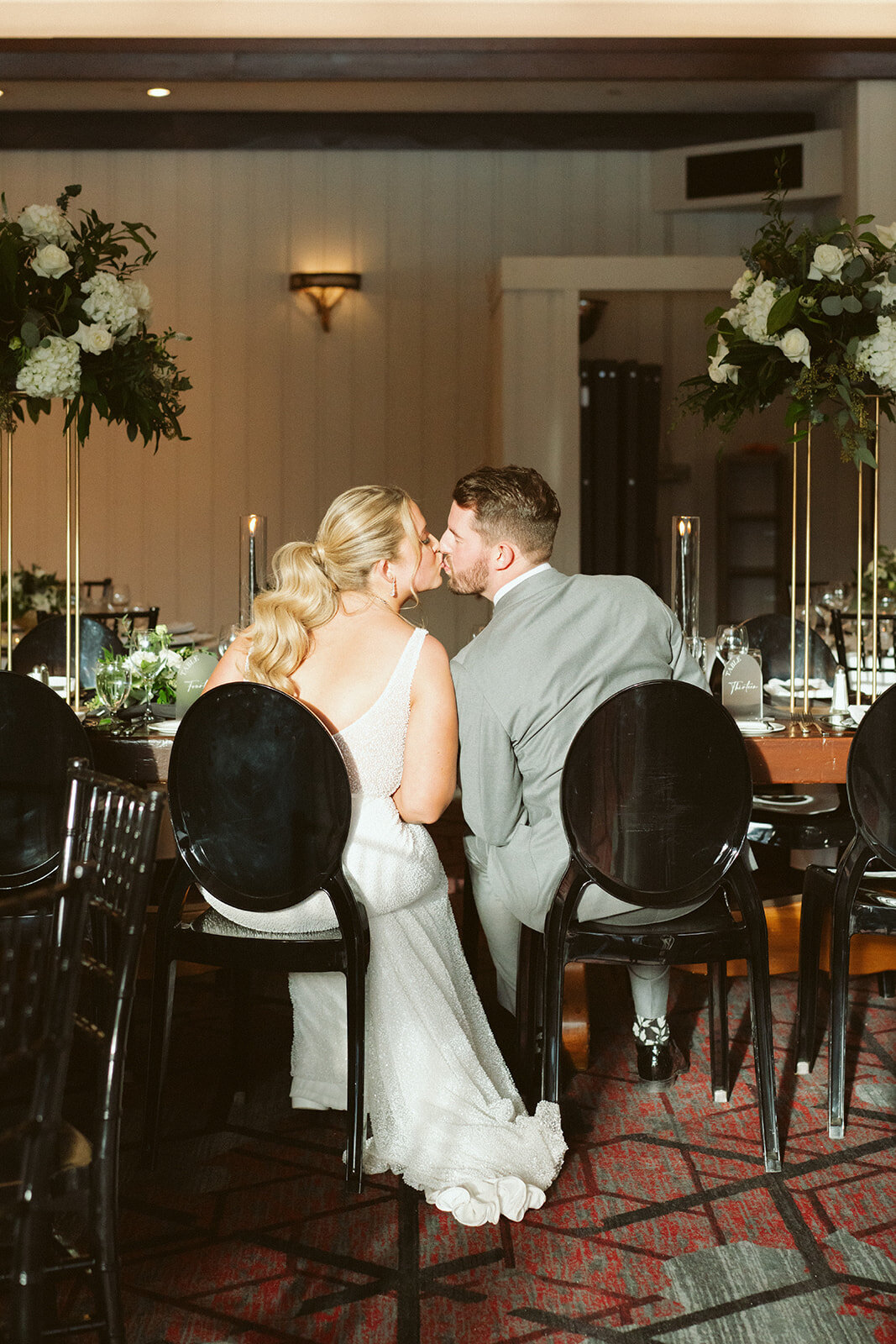 Bride and groom sharing a kiss at the wedding reception.