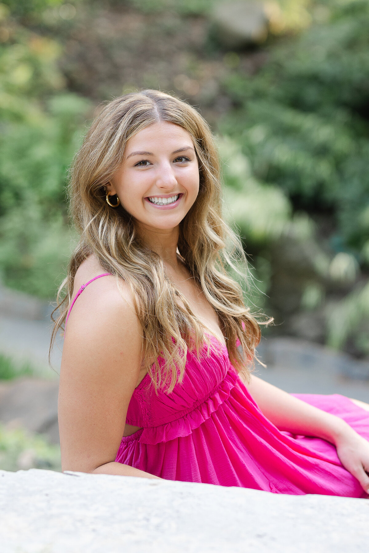 High school senior posing with a confident smile at a scenic park in Columbus, Ohio.
