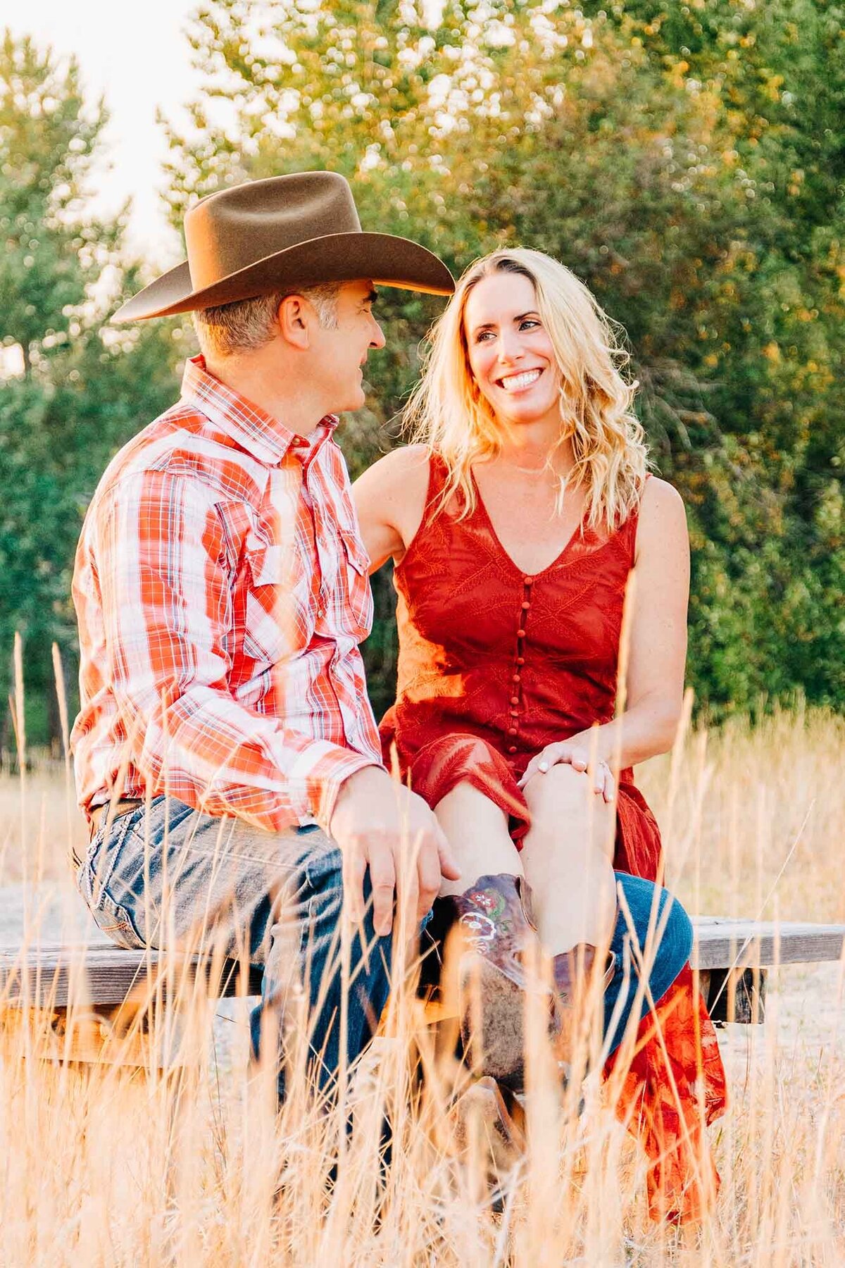 Montana engaged couple sitting together at Travelers' Rest State Park, Lolo