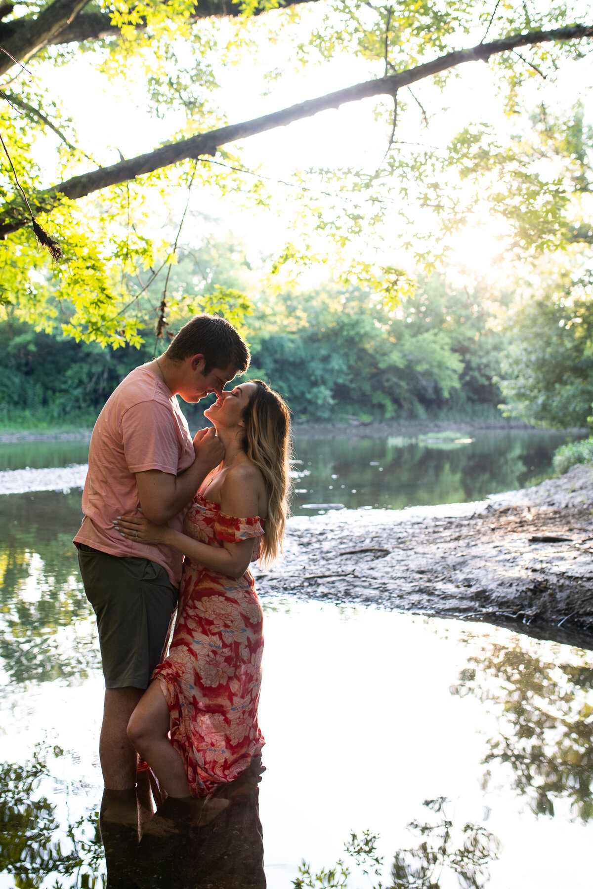 Couple snuggles in the water at their engagement session