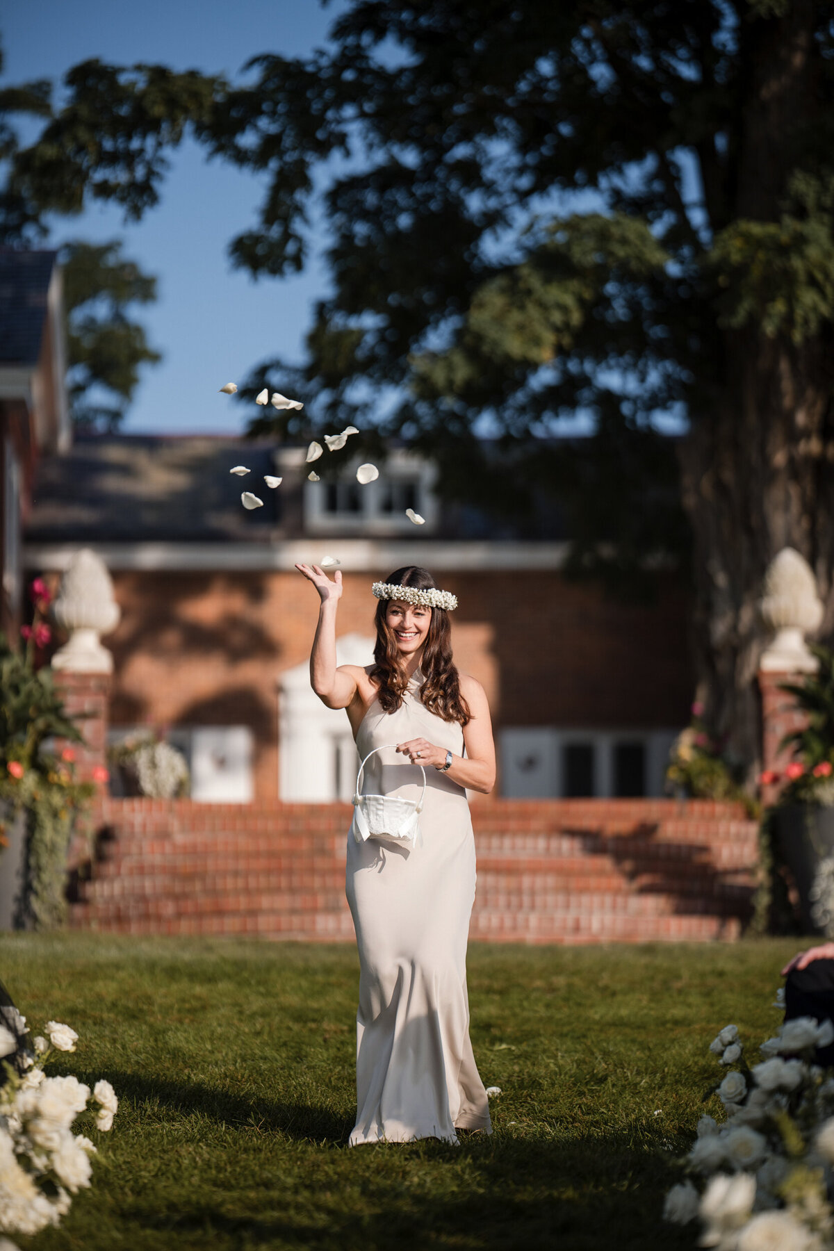 A woman tosses petals at a destination wedding in Vermont