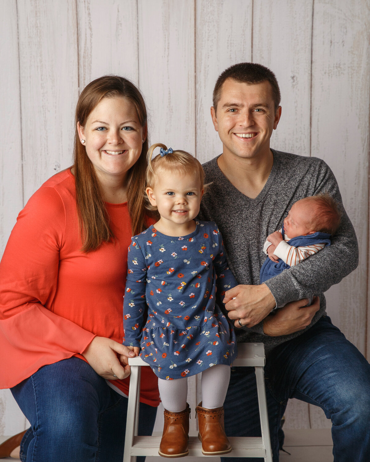 Family Portrait of Mom and dad with young daughter and newborn baby boy