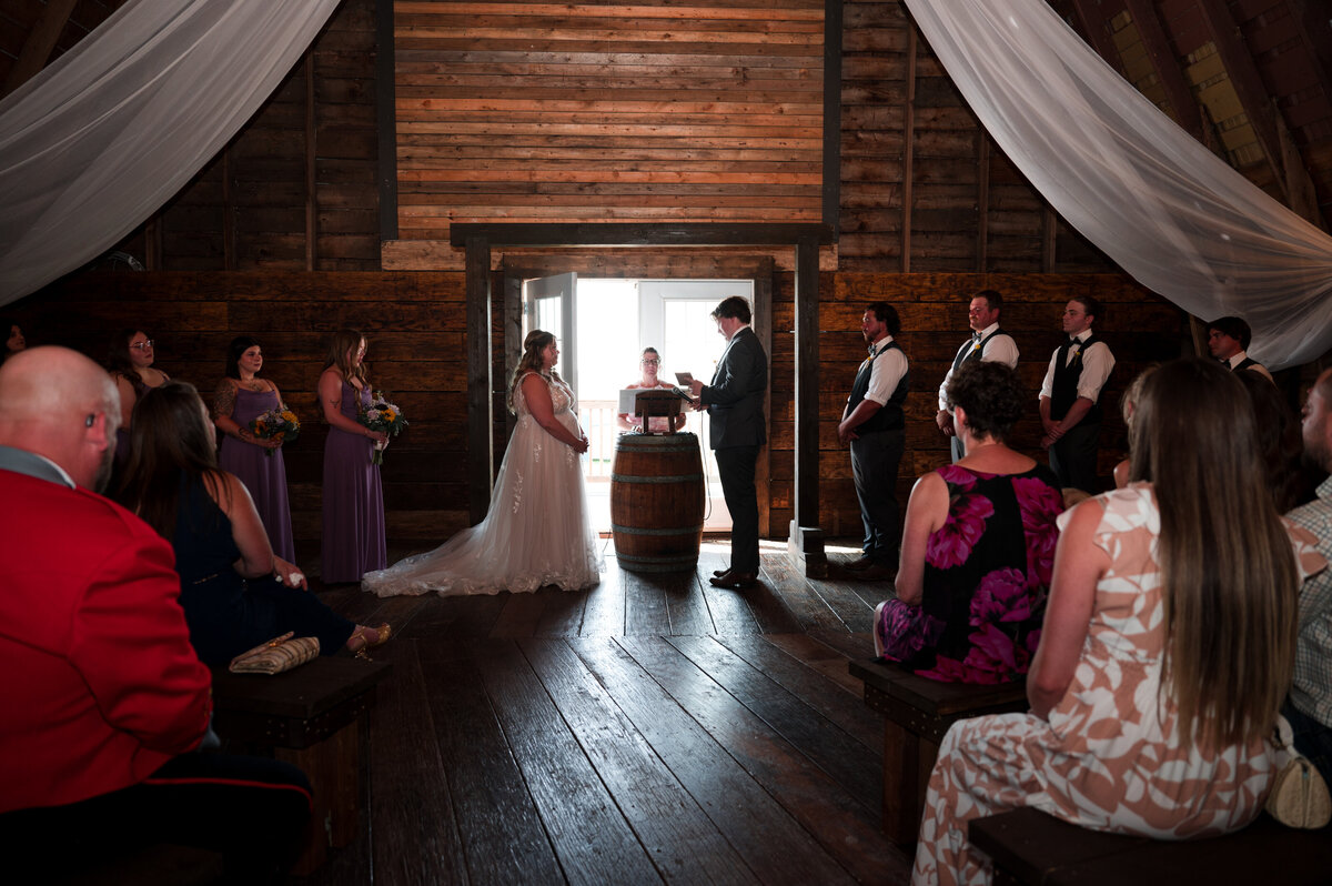 Wedding ceremony in a barn at Falkenberg Stables in Leduc, Alberta
