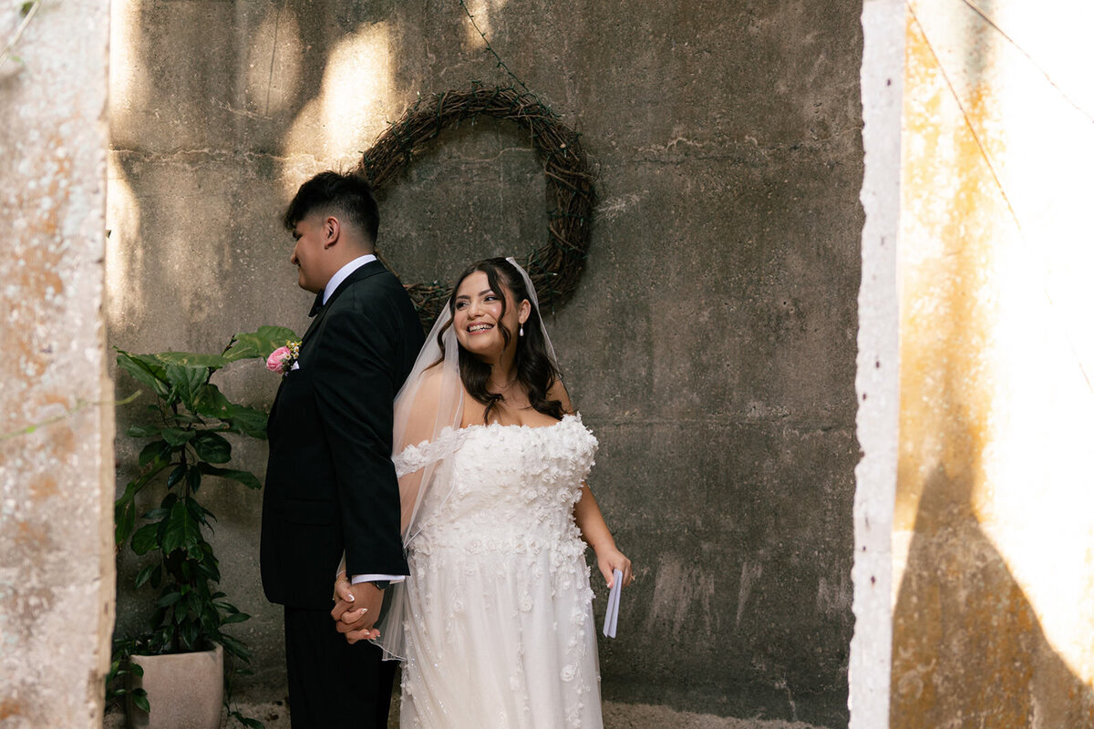 Romantic wedding portrait of bride and groom near textured wall at Uliana Estate in Lakeland FL.