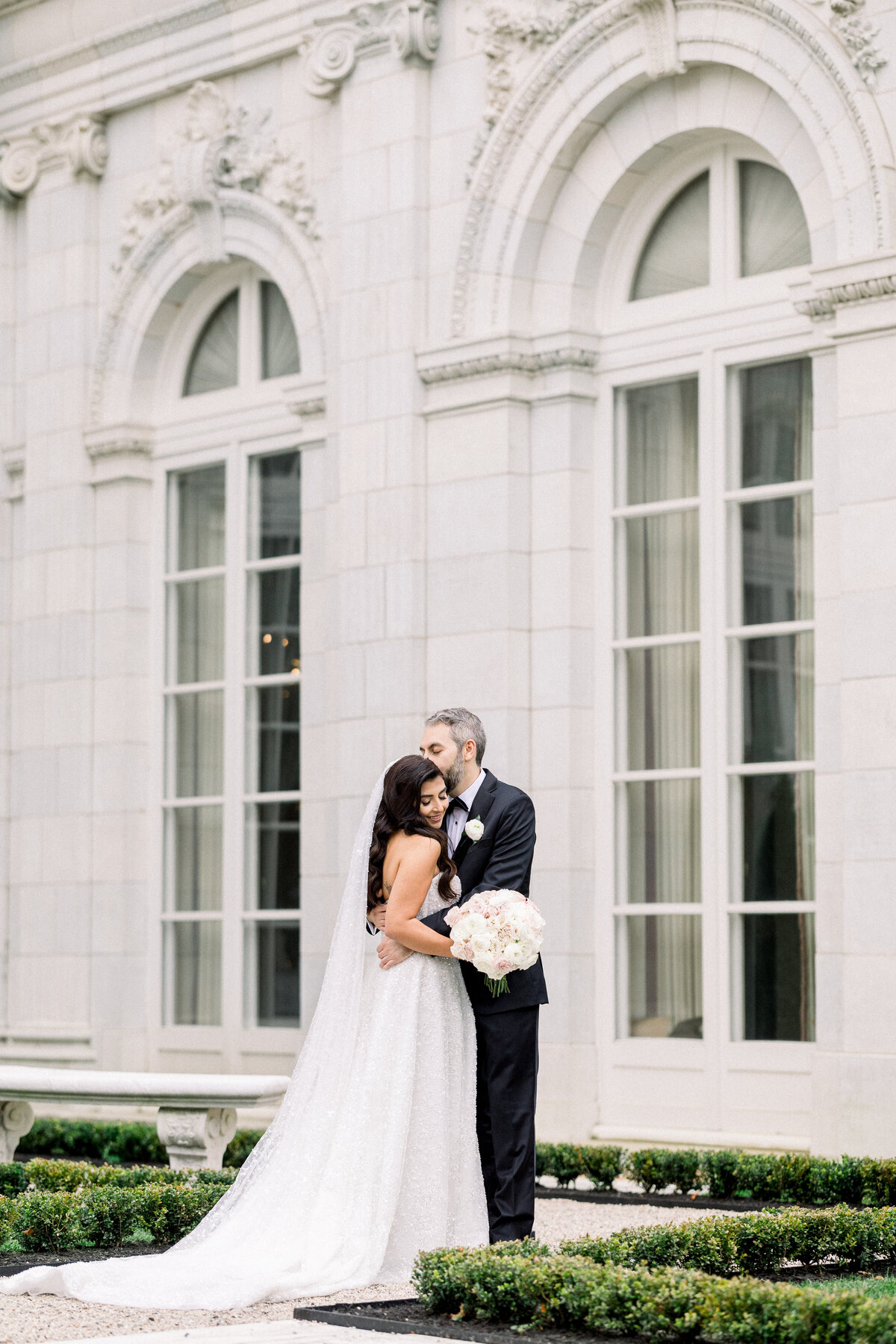 bride and groom embrace during first look at rosecliff mansion in newport rhode island