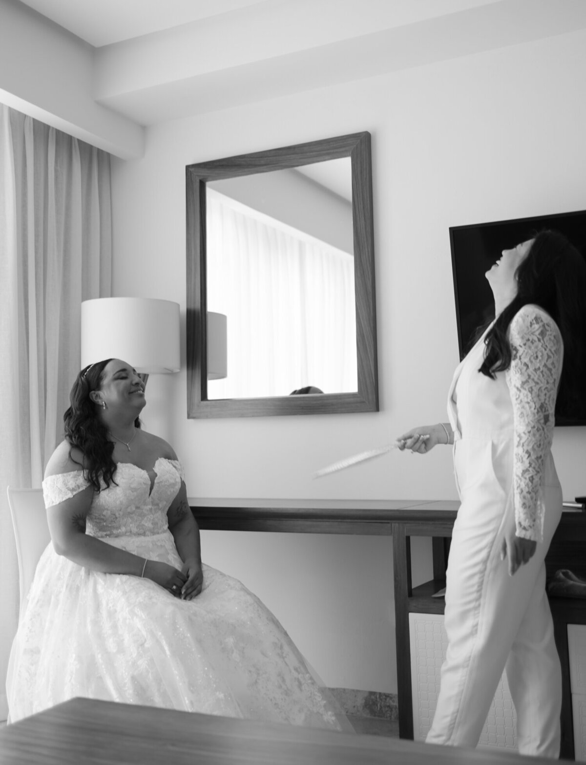 same sex wedding in Mexico, bride fans her bride in Mexico heat, Paradisus