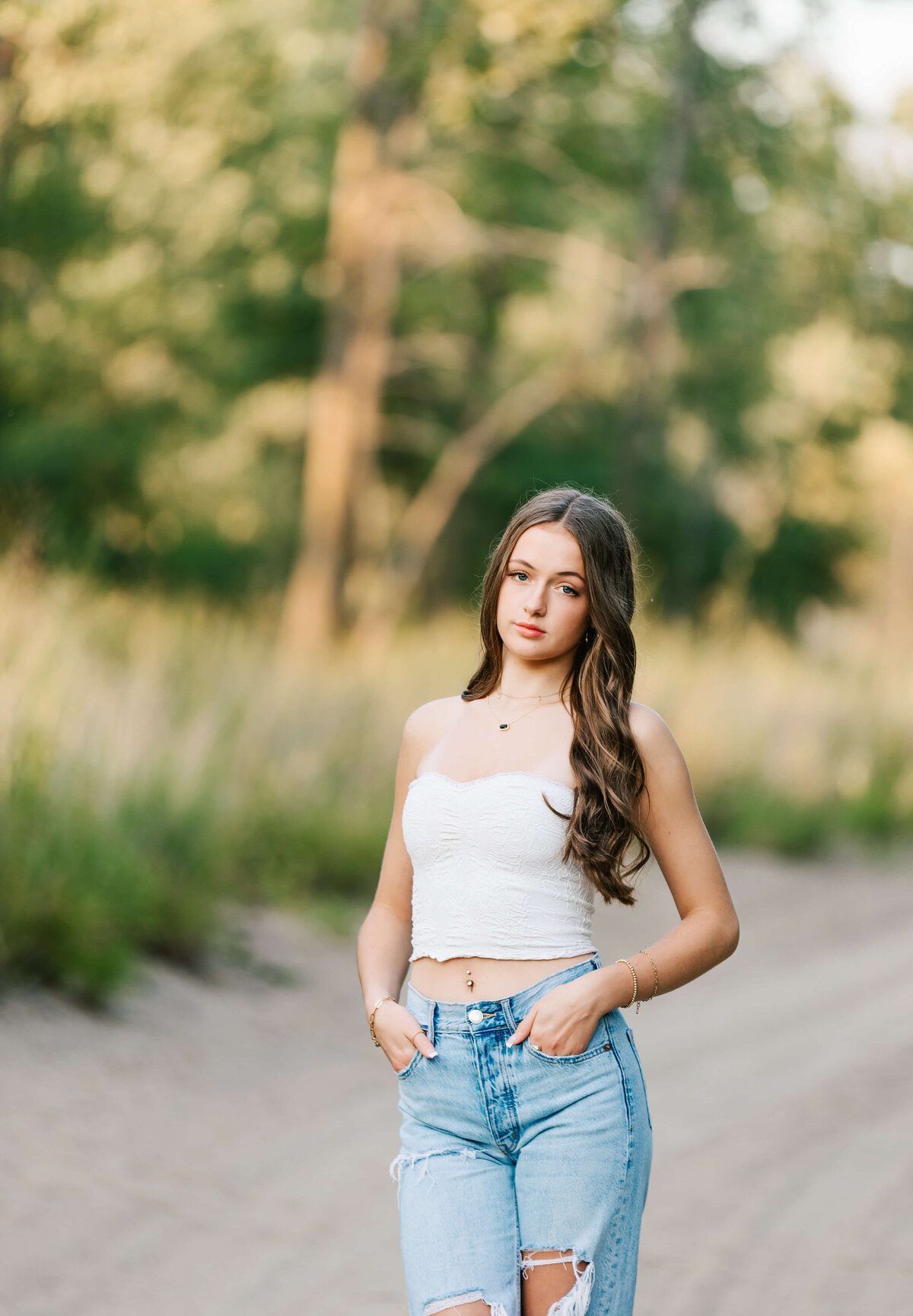 Senior portrait of a girl standing in the sand at Presque Isle in Erie Pa