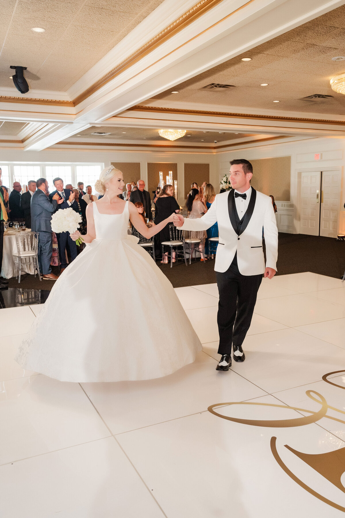 bride and groom waking into their wedding ballroom at The Grand Resort to celebrate